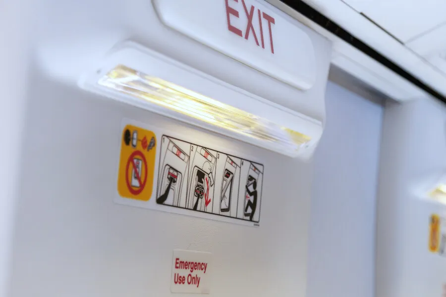 Airplane emergency exit with instruction signs.